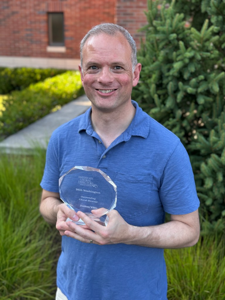 Current image: Joshua Viles pictured with his crystal circle award July 2025.